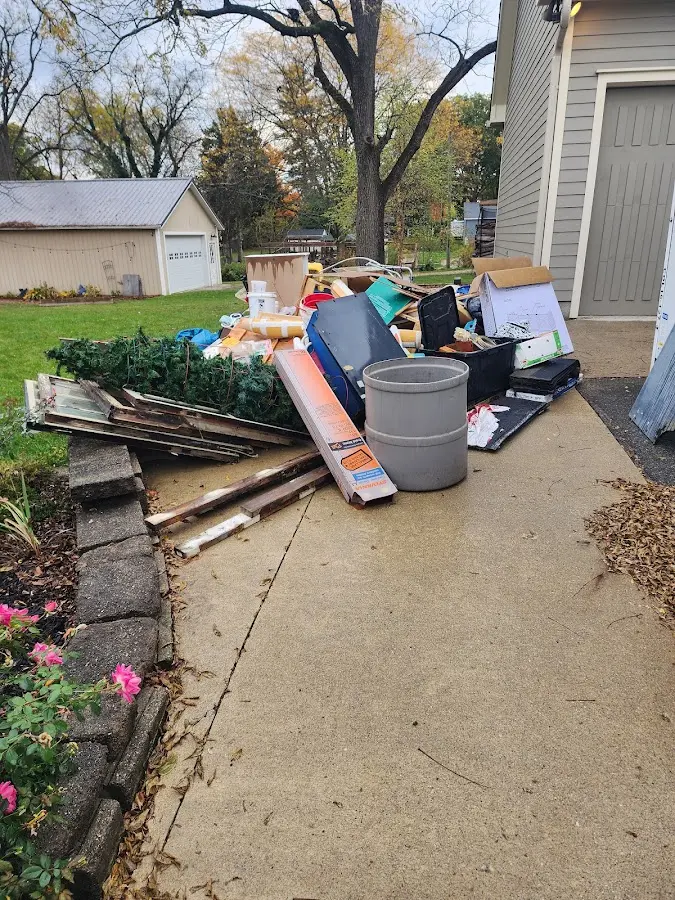 Dumpster being loaded with debris for Roofing Dumpster Rental in Hampstead